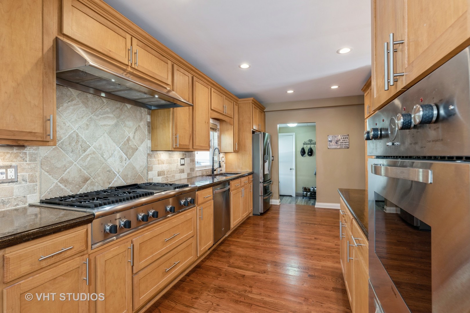 1438 Ridge Road Homewood, IL 60430 - Photo 9 of 35 a kitchen with stainless steel appliances granite countertop a stove a sink and a refrigerator