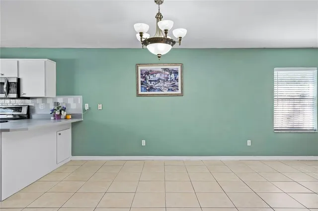a kitchen with stainless steel appliances granite countertop a refrigerator sink and stove