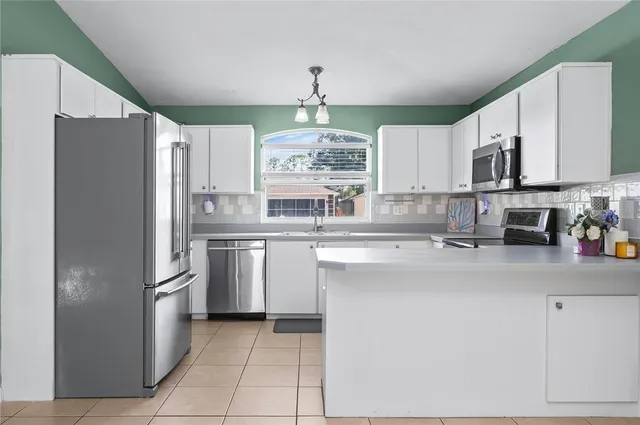 a kitchen with stainless steel appliances a stove sink microwave and cabinets
