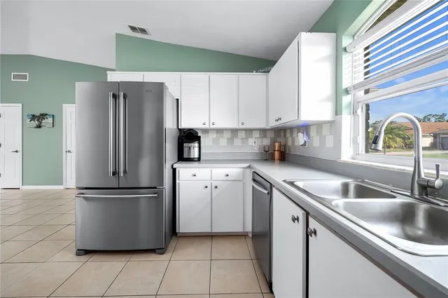 a spacious bedroom that has a bed and a window