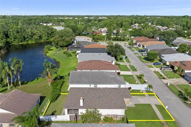 an aerial view of residential houses with outdoor space and street view