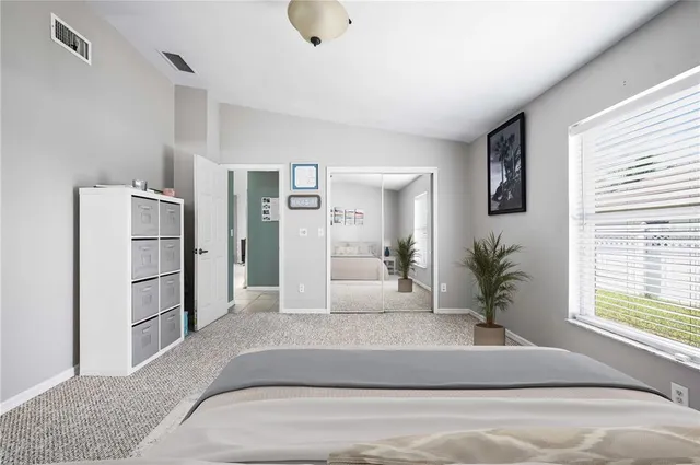 a view of a livingroom with a refrigerator cabinets and a window