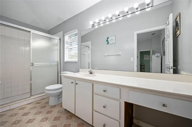 a bedroom with a bed and a potted plant