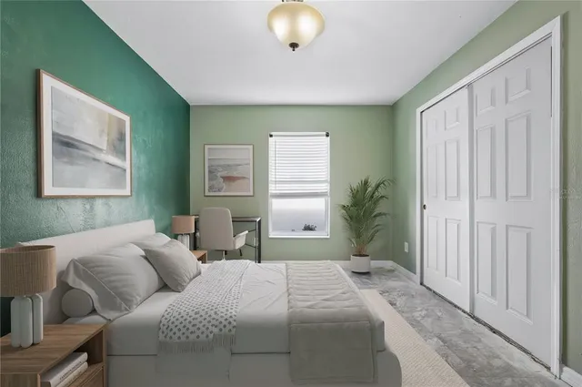 a view of an empty room with window and closet area