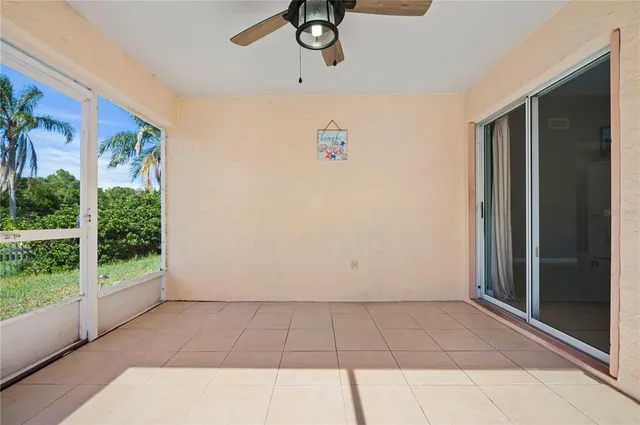 a view of livingroom with floor to ceiling window and a ceiling fan
