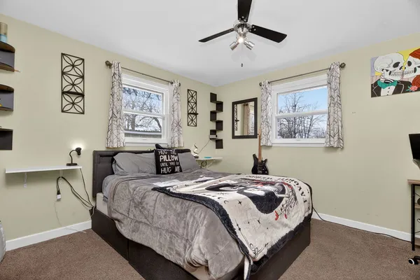 a bedroom with a bed and a chandelier
