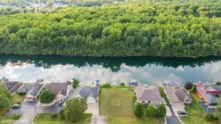 an aerial view of residential house with outdoor space and lake view