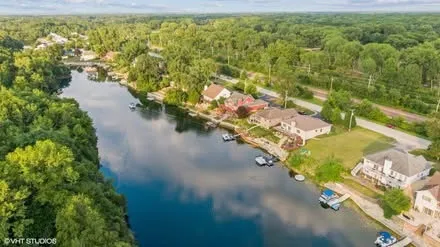an aerial view of residential house with pool yard and outdoor seating