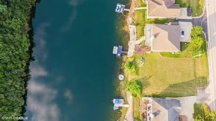 an aerial view of a house with a lake view