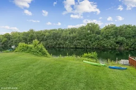 a view of a lake with houses in the back