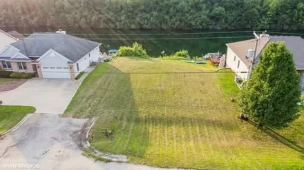 an aerial view of a house with a yard and a garden
