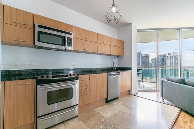 a kitchen with stainless steel appliances granite countertop a stove and a microwave
