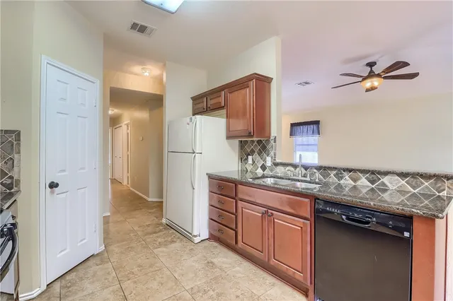 a bathroom with a granite countertop sink a mirror and a shower