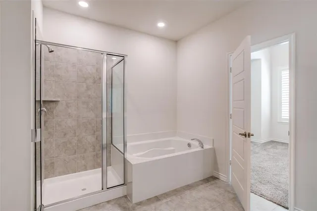 a bathroom with a bathtub and a shower