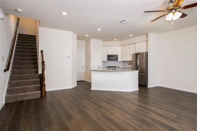 a view of kitchen with cabinets and wooden floor