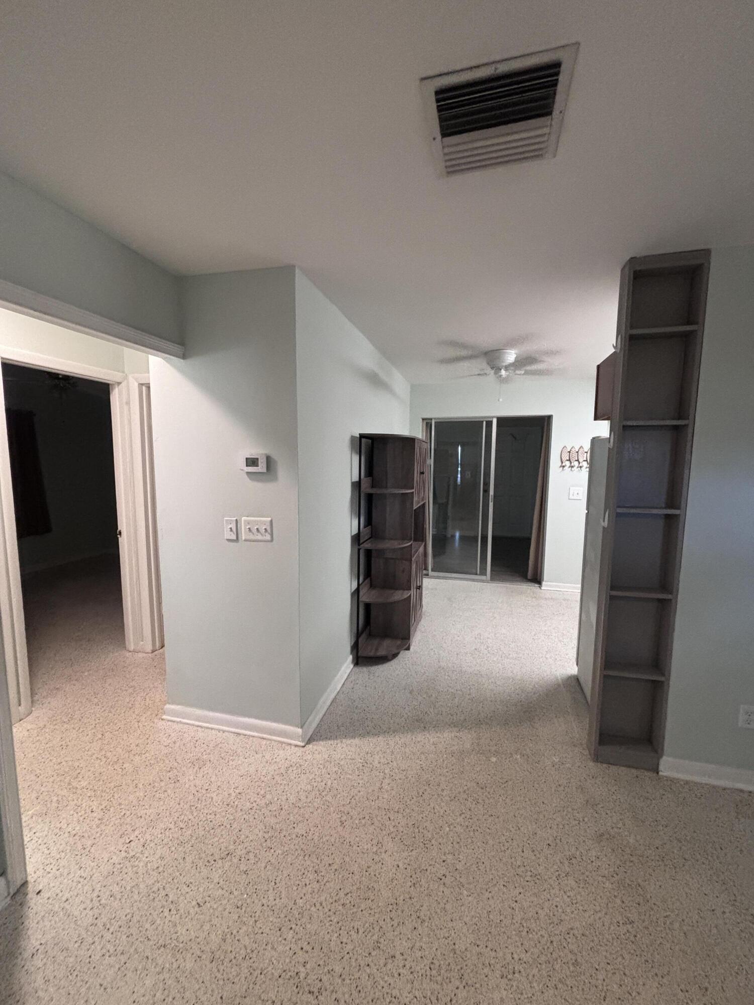 202 Balboa Street, Unit A Fort Pierce, FL 34949 - Photo 5 of 10 a view of a livingroom with a refrigerator and a window