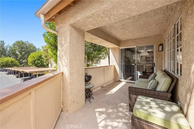 a balcony with furniture and a window