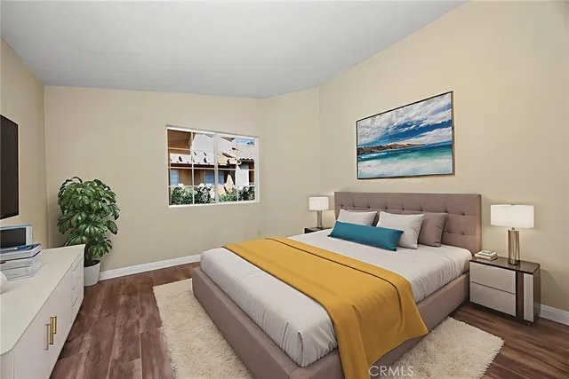 a bedroom with bed and wall painting with wooden floor