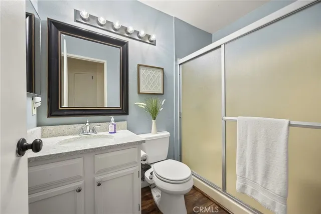 a bathroom with a toilet a sink and a mirror