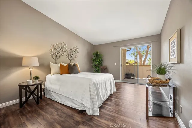 a bedroom with a bed a mirror and a window