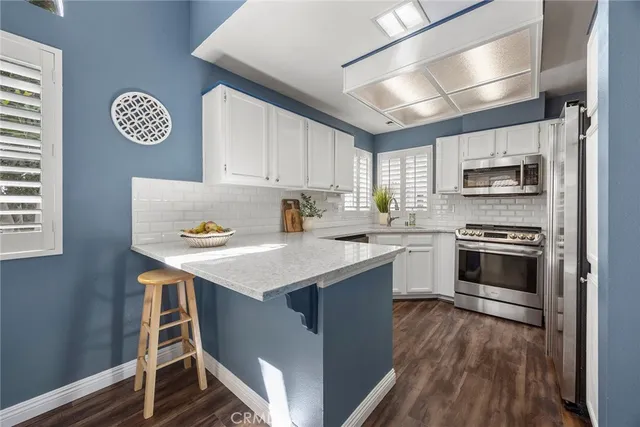 a kitchen with a stove window and a refrigerator