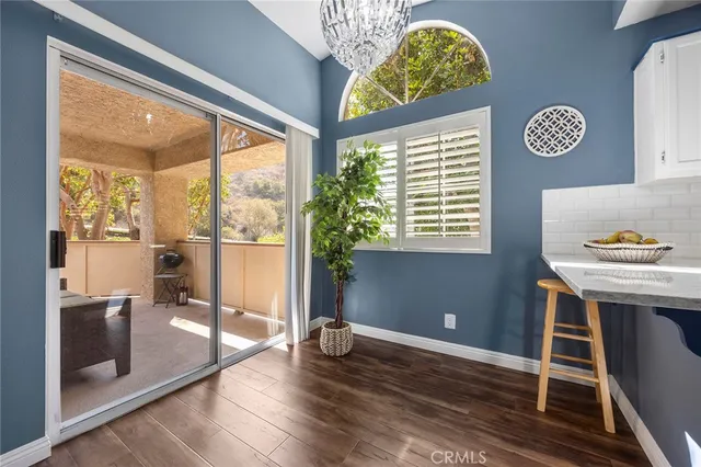 a view of a dining room with furniture and a window
