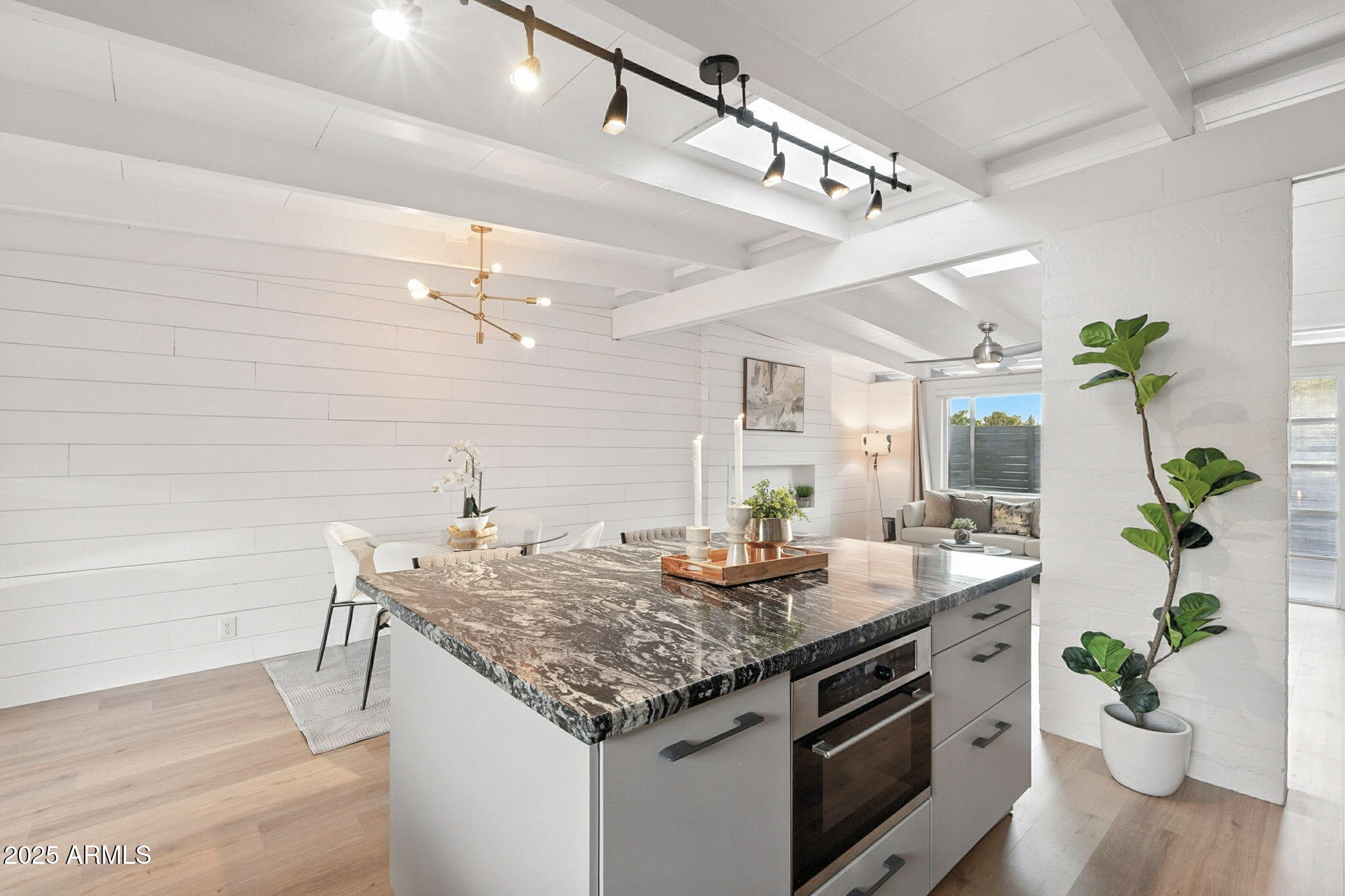 5809 North 10th Place Phoenix, AZ 85014 - Photo 13 of 81 a kitchen with a granite countertop cabinets a potted plant on the counter and wooden floors
