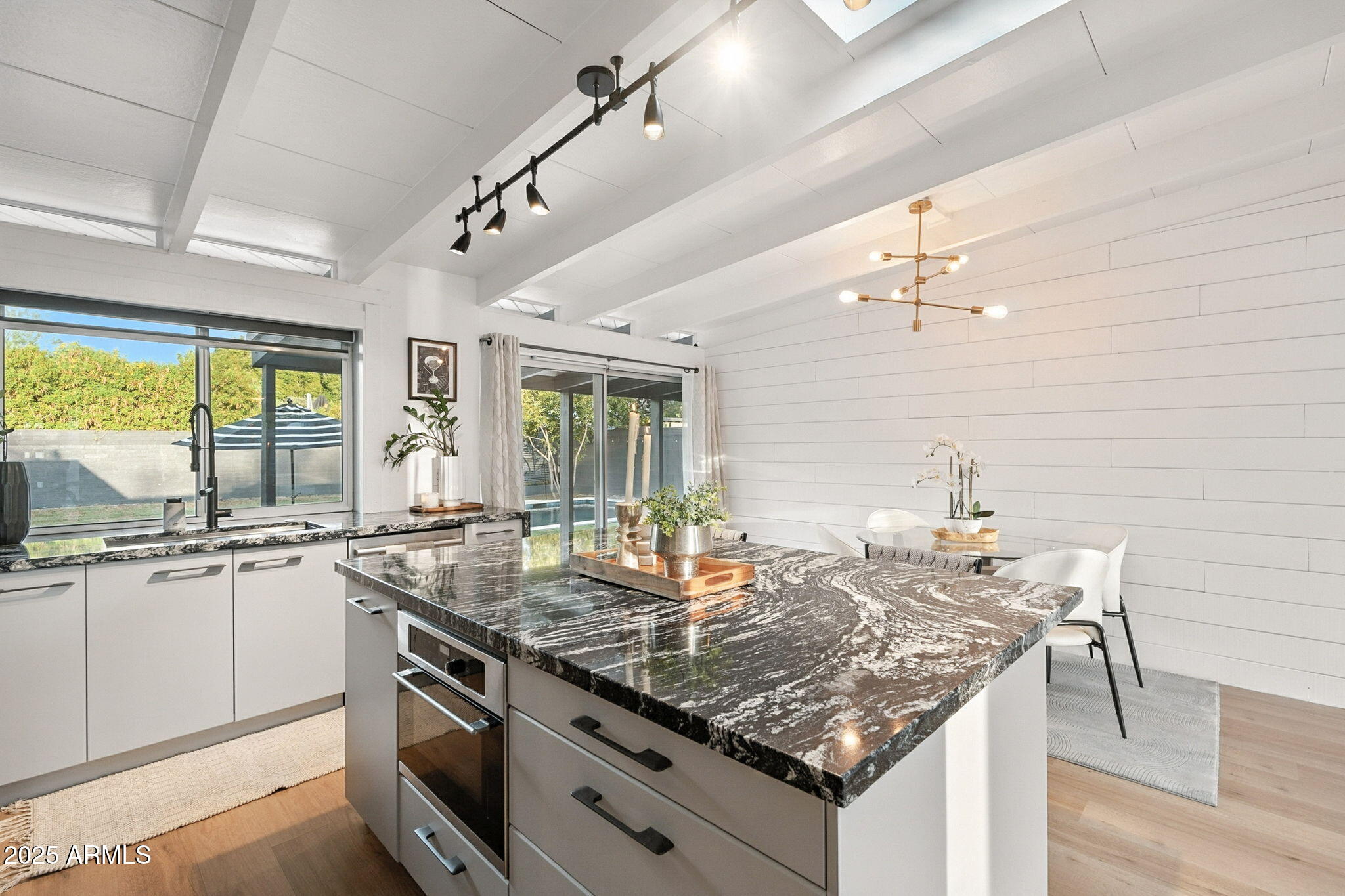 5809 North 10th Place Phoenix, AZ 85014 - Photo 14 of 81 a kitchen with granite countertop stainless steel appliances a sink stove and cabinets