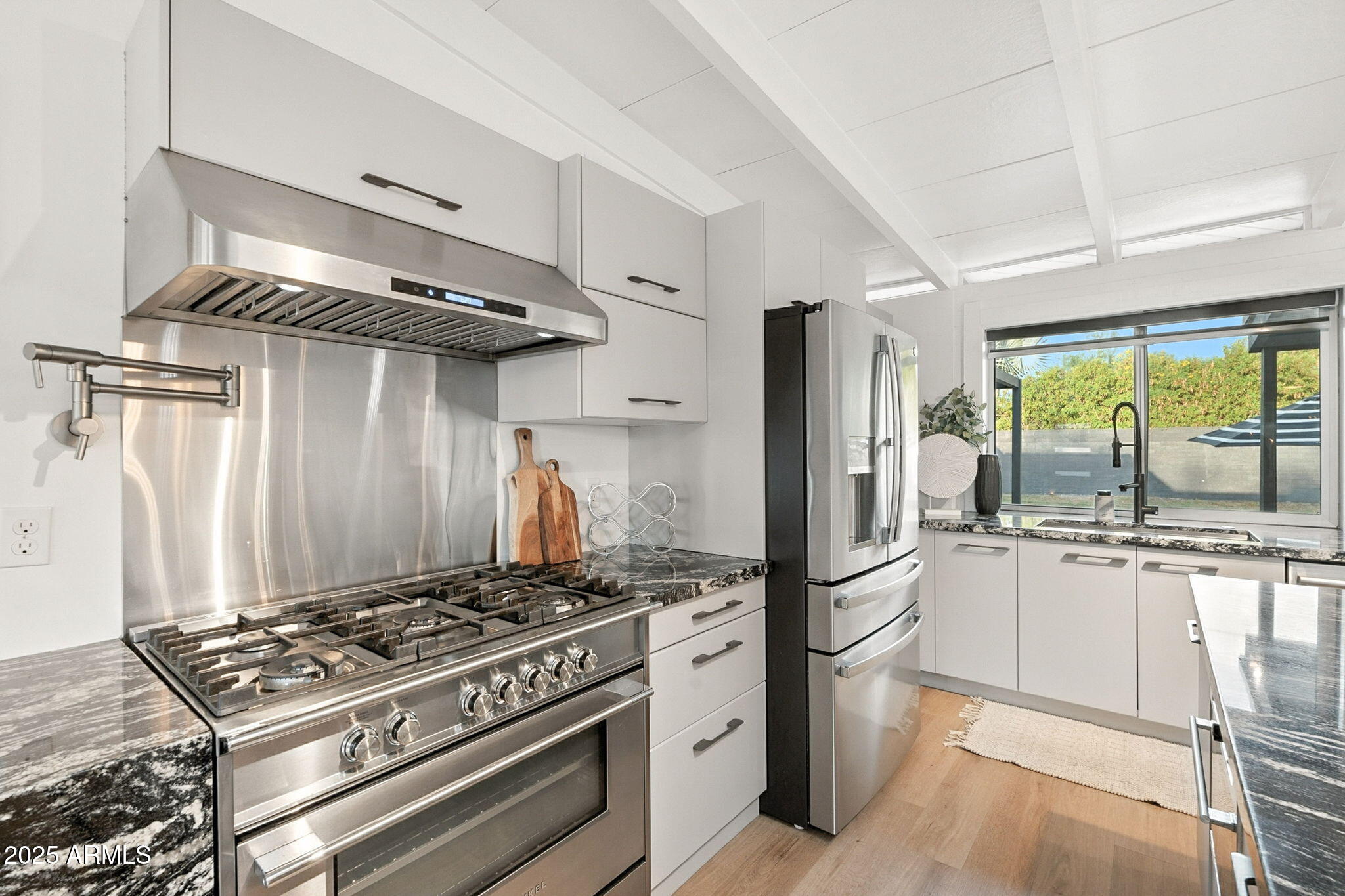 5809 North 10th Place Phoenix, AZ 85014 - Photo 15 of 81 a kitchen with stainless steel appliances granite countertop a stove and a refrigerator