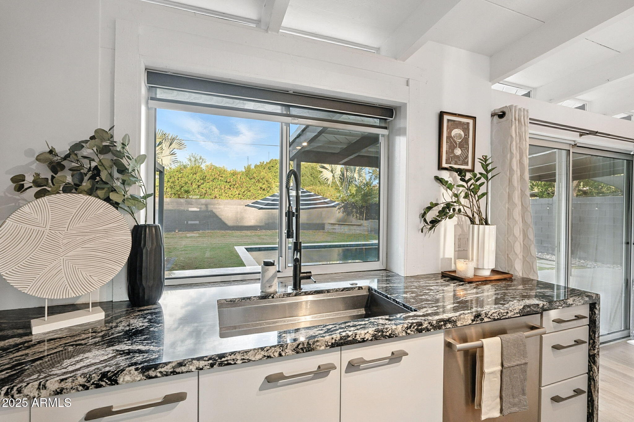 5809 North 10th Place Phoenix, AZ 85014 - Photo 18 of 81 a kitchen with kitchen island granite countertop a stove a sink and a granite counter tops