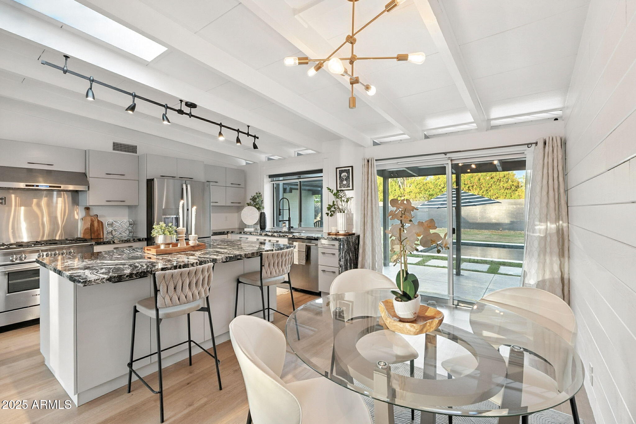 5809 North 10th Place Phoenix, AZ 85014 - Photo 21 of 81 a very nice looking dining room with kitchen island furniture a large window and kitchen view