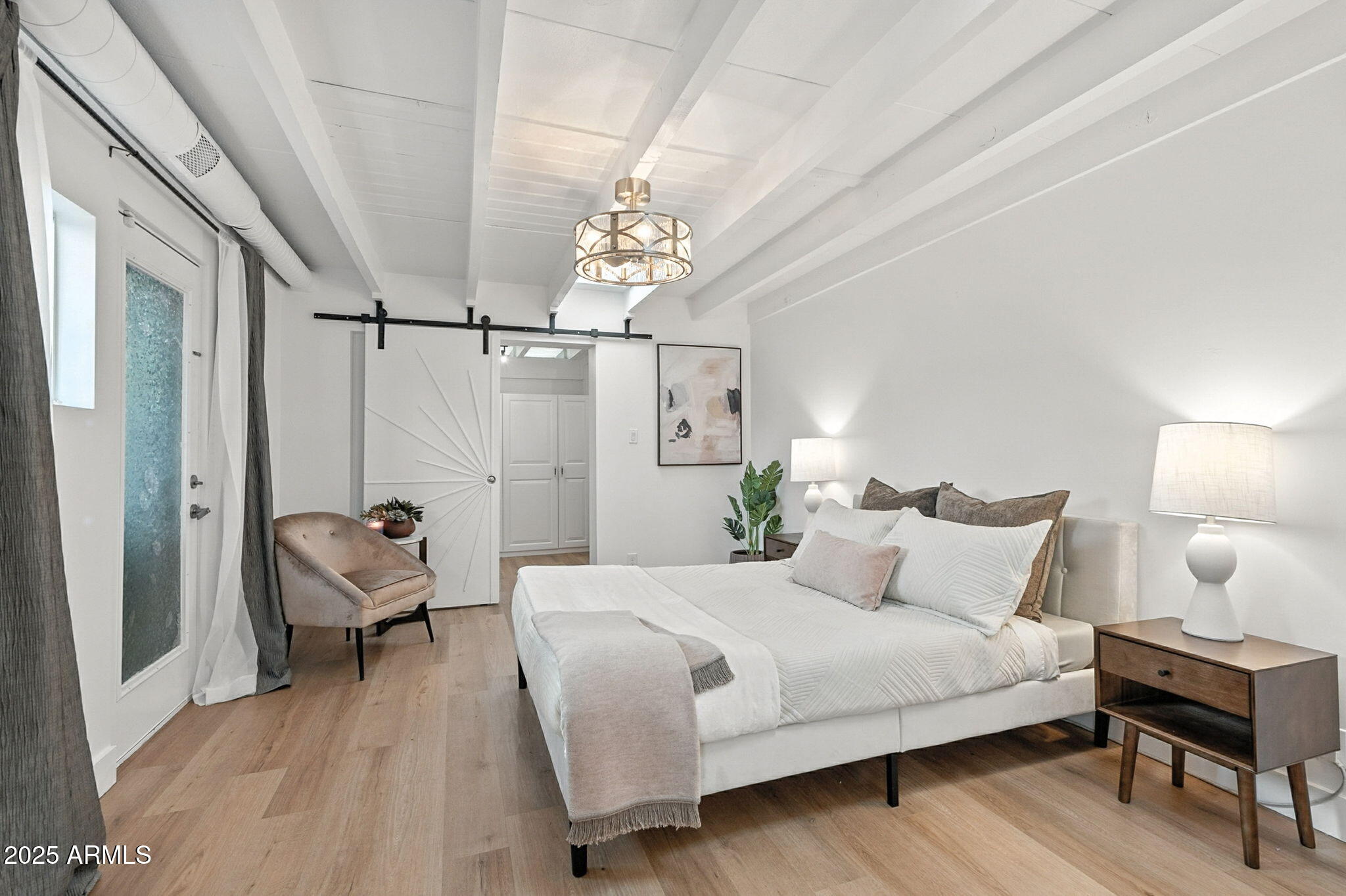 5809 North 10th Place Phoenix, AZ 85014 - Photo 22 of 81 a bedroom with a bed and a chair with the potted plant