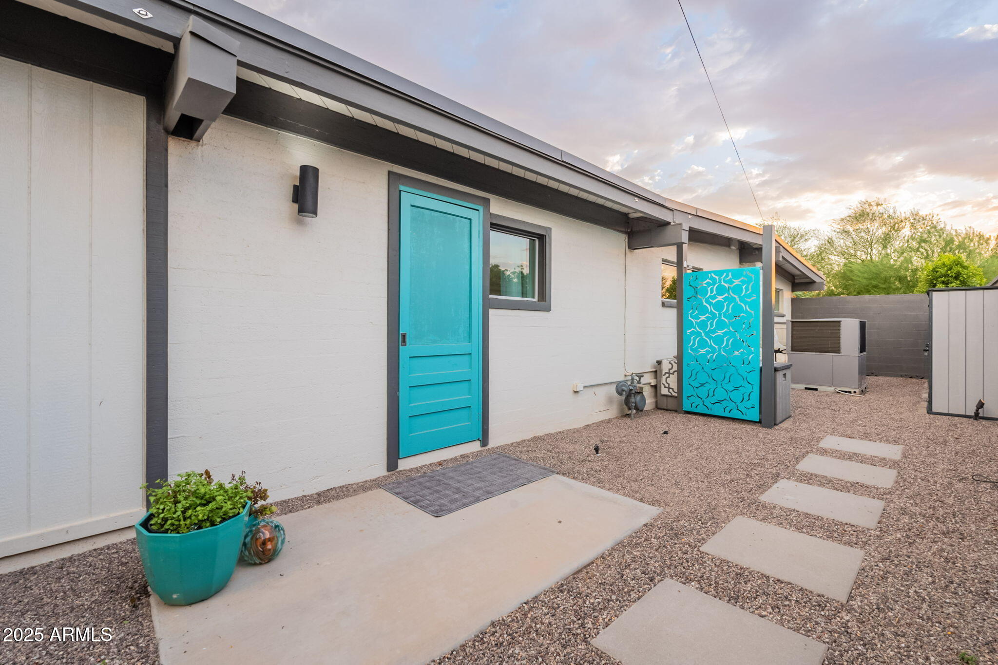 5809 North 10th Place Phoenix, AZ 85014 - Photo 56 of 81 a backyard of a house with potted plants and a table