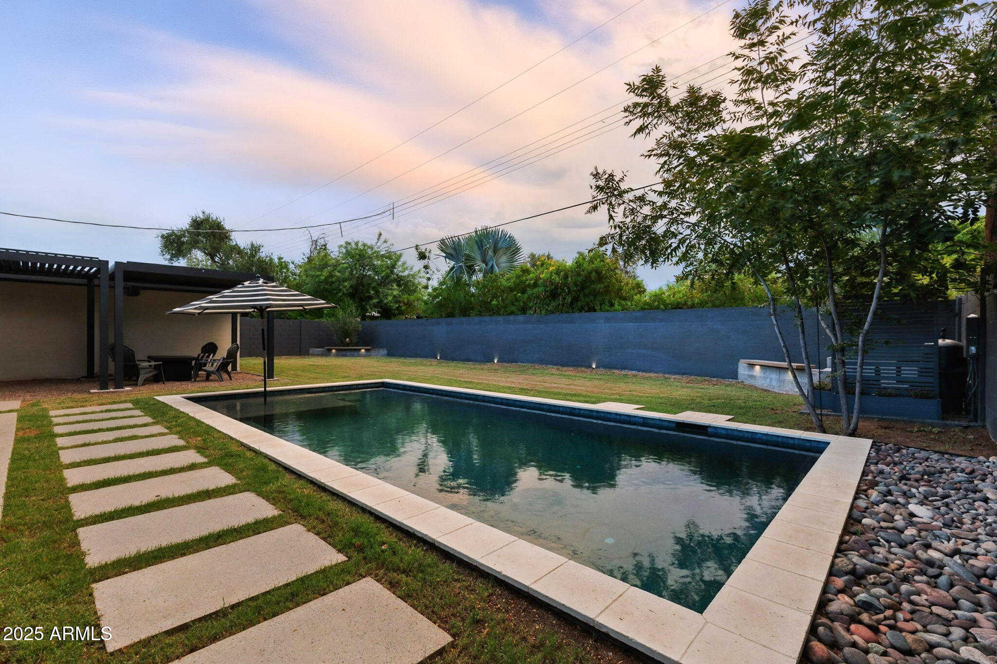 5809 North 10th Place Phoenix, AZ 85014 - Photo 61 of 81 a view of swimming pool that has wooden bench in front of house