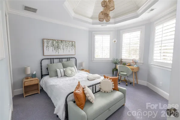 a view of a hallway with wooden floor and a dining room