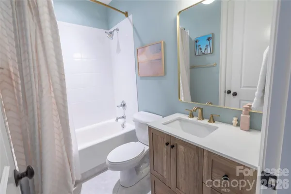 a bathroom with a granite countertop sink and shower
