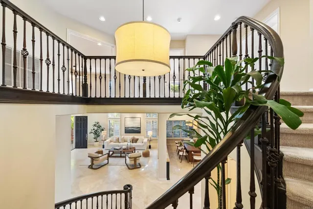 a bedroom with a bed couch and large window