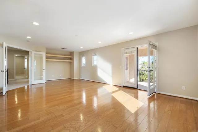 a view of a park and trees with wooden fence