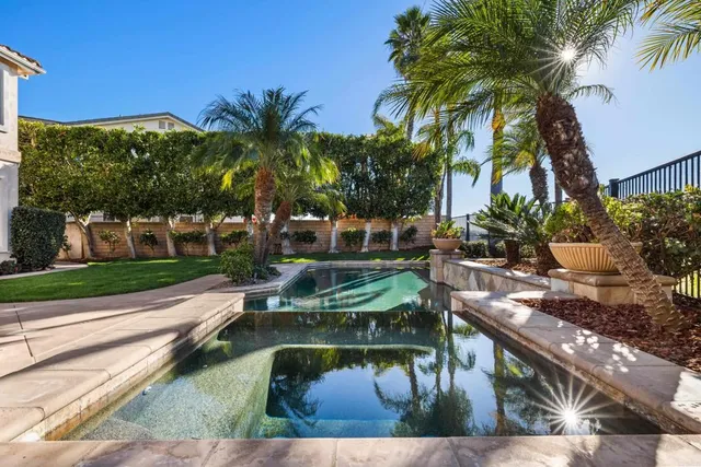 an aerial view of a house with garden space ocean and outdoor seating