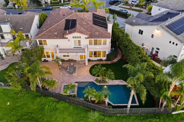 a front view of a house with a yard and potted plants