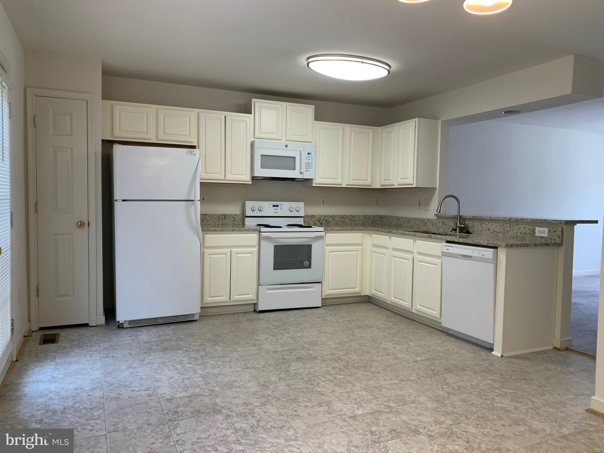 208 Torbert Loop Stafford, VA 22554 - Photo 3 of 16 a kitchen with white cabinets stainless steel appliances and sink