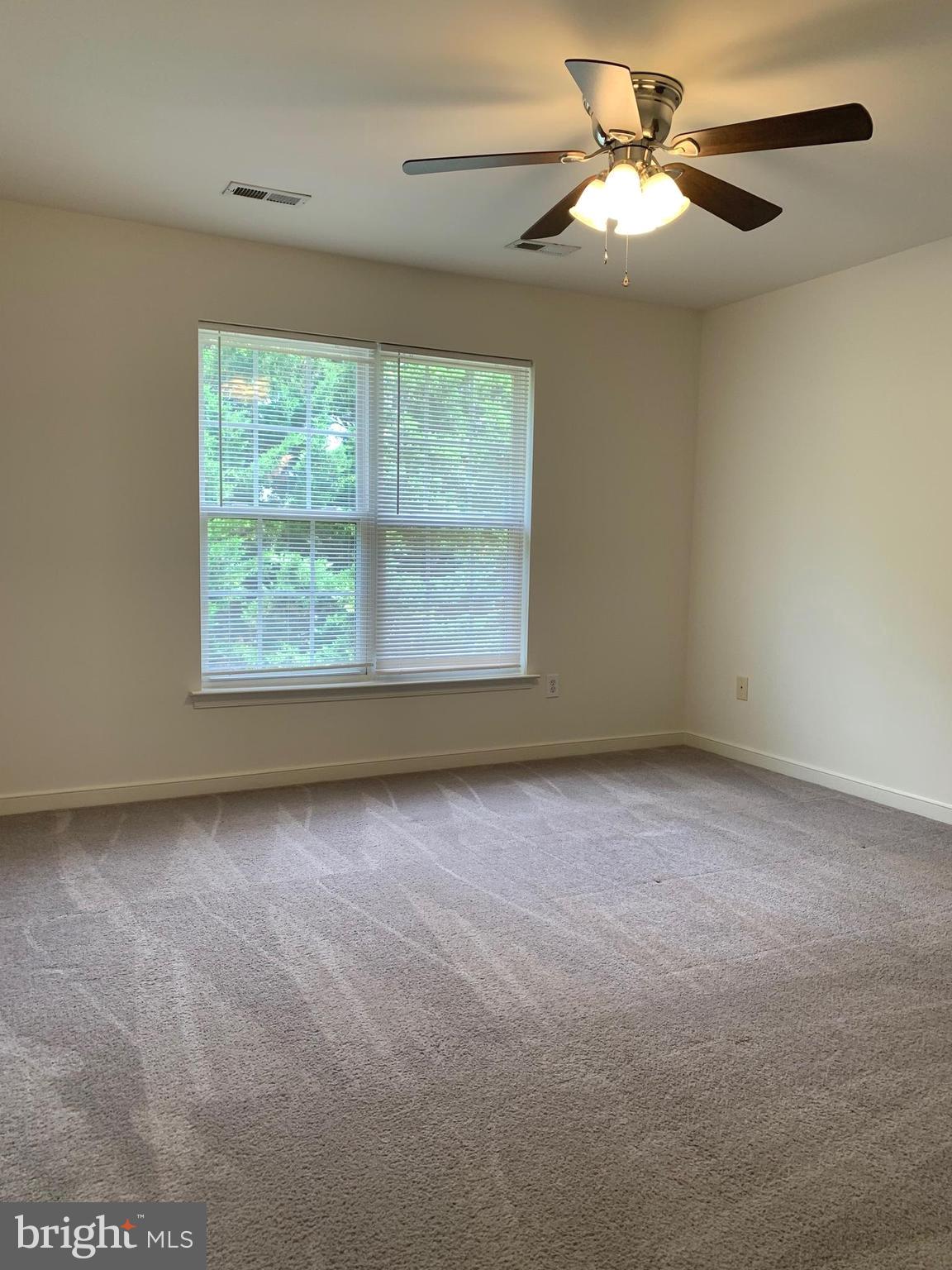 208 Torbert Loop Stafford, VA 22554 - Photo 9 of 16 an empty room with a window and a fan