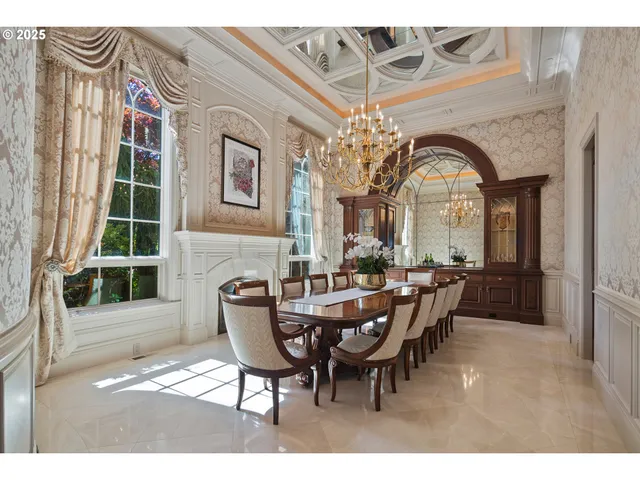 a view of a dining room with furniture and chandelier