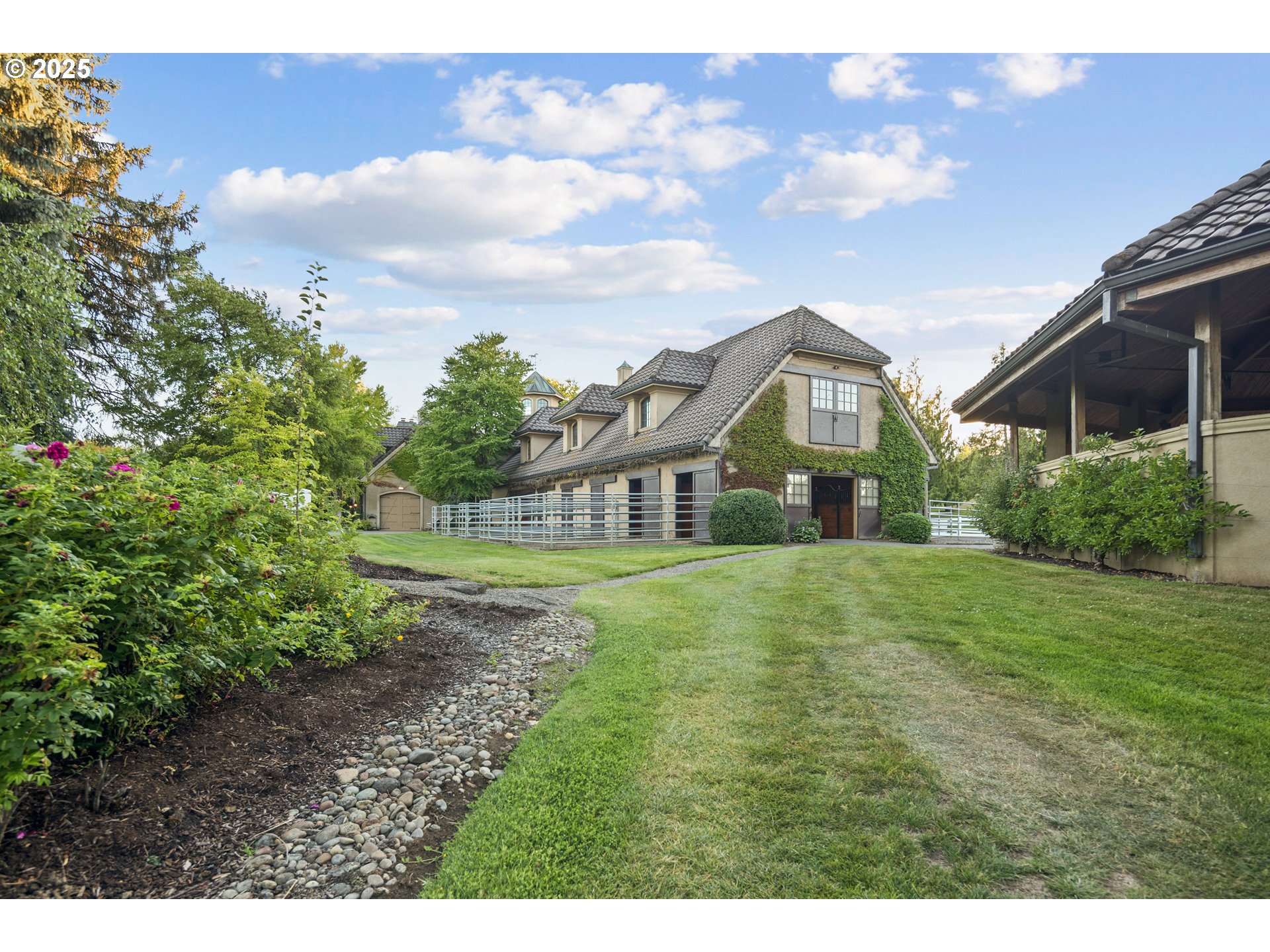 21121 Northwest 17th Court Ridgefield, WA 98642 - Photo 32 of 48 a view of a big house with a big yard and large trees