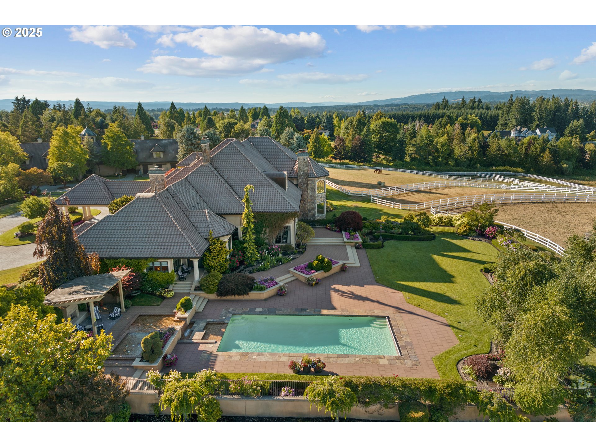 21121 Northwest 17th Court Ridgefield, WA 98642 - Photo 4 of 48 an aerial view of a house with a garden and lake view