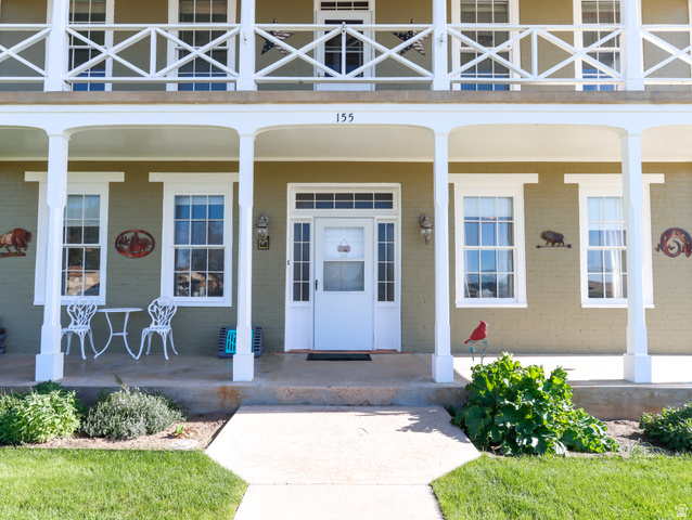 155 West Center Street Fillmore, UT 84631 - Photo 8 of 86 Exterior facade featuring a covered porch with white columns, a second-story balcony with decorative railing, and multiple double-hung windows