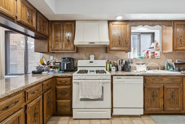 a kitchen with cabinets appliances a sink and a counter top space