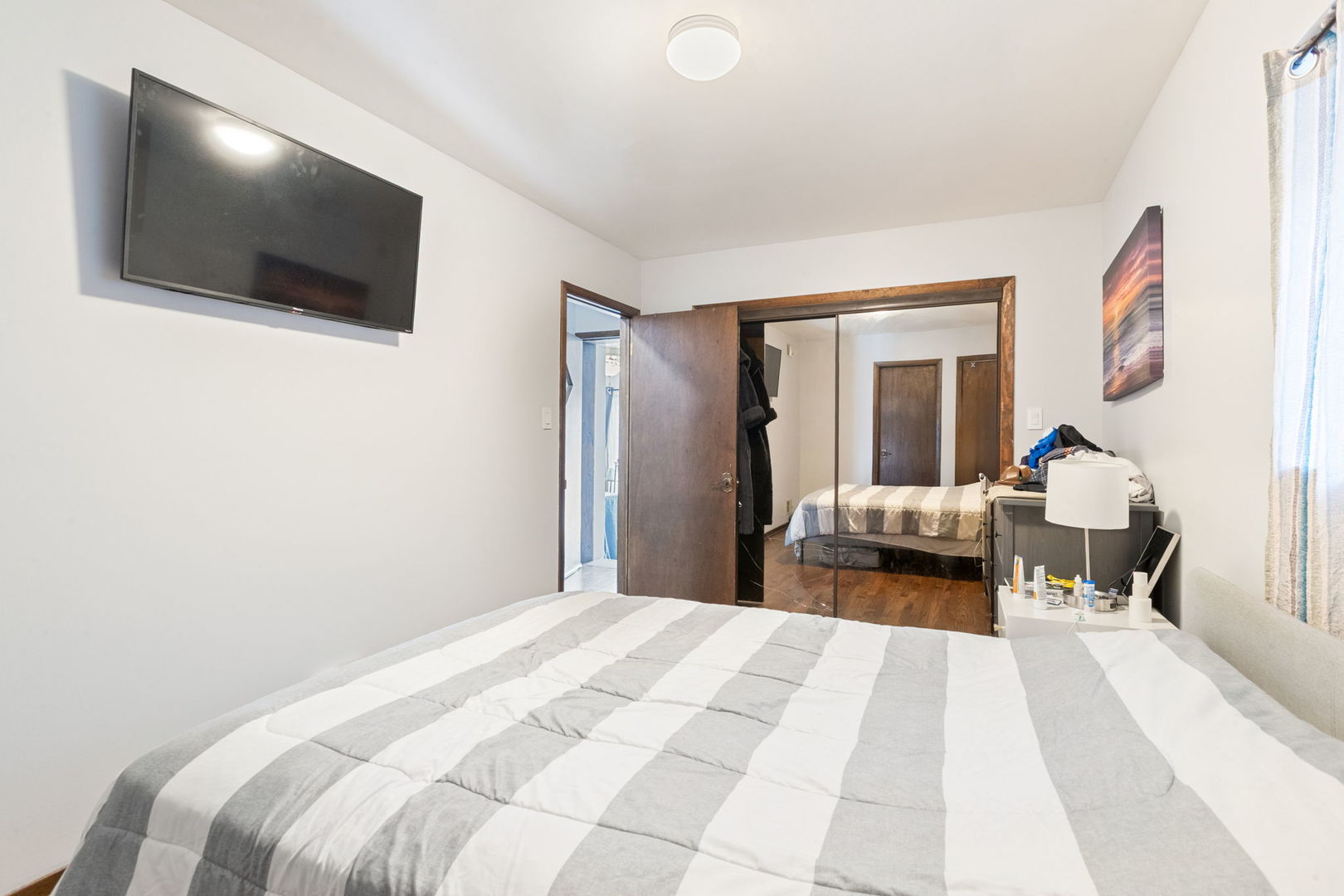 3234 South Princeton Avenue Chicago, IL 60616 - Photo 19 of 56 a bedroom with a bed and a flat screen tv