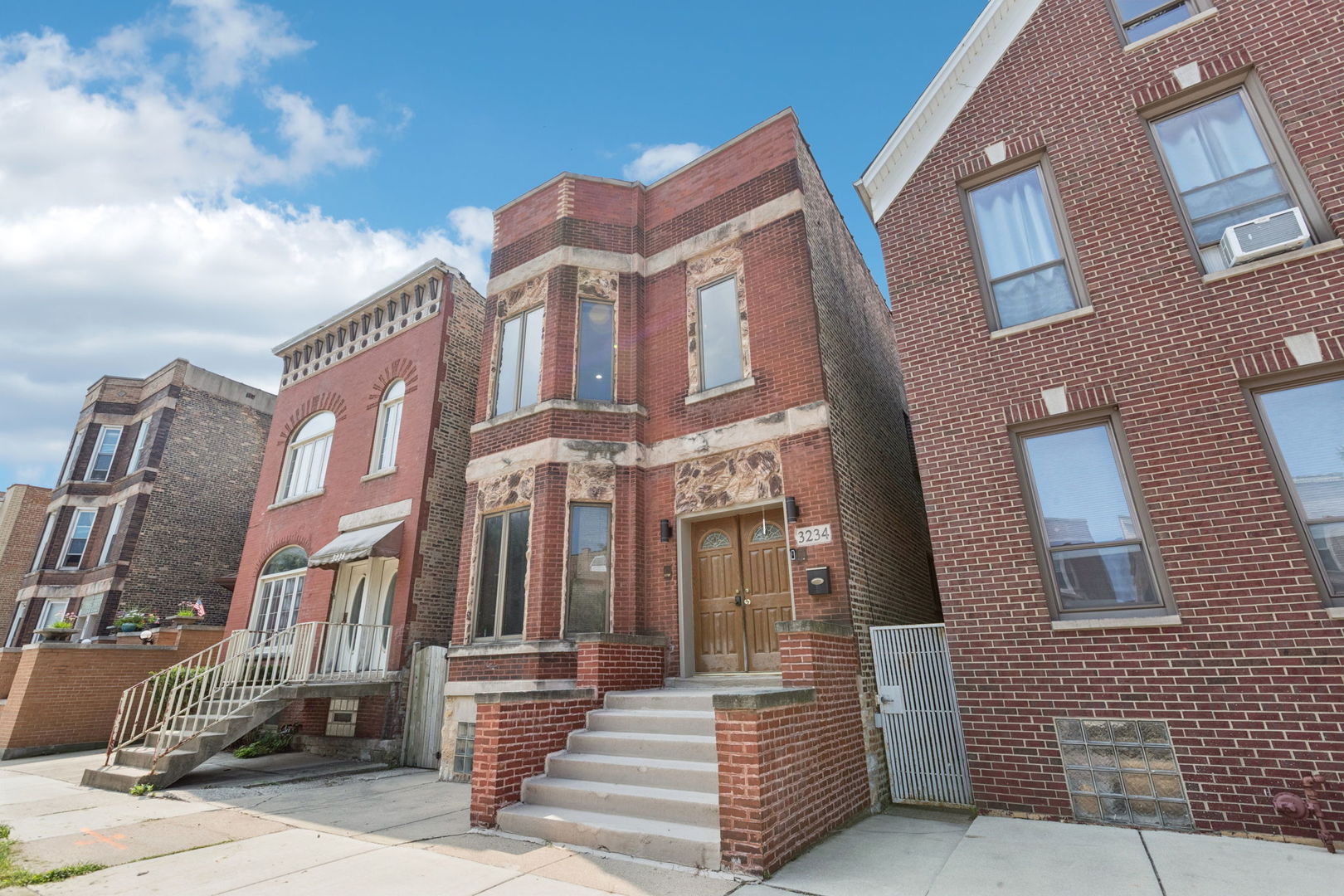 3234 South Princeton Avenue Chicago, IL 60616 - Photo 3 of 56 a front view of a multi story residential apartment building