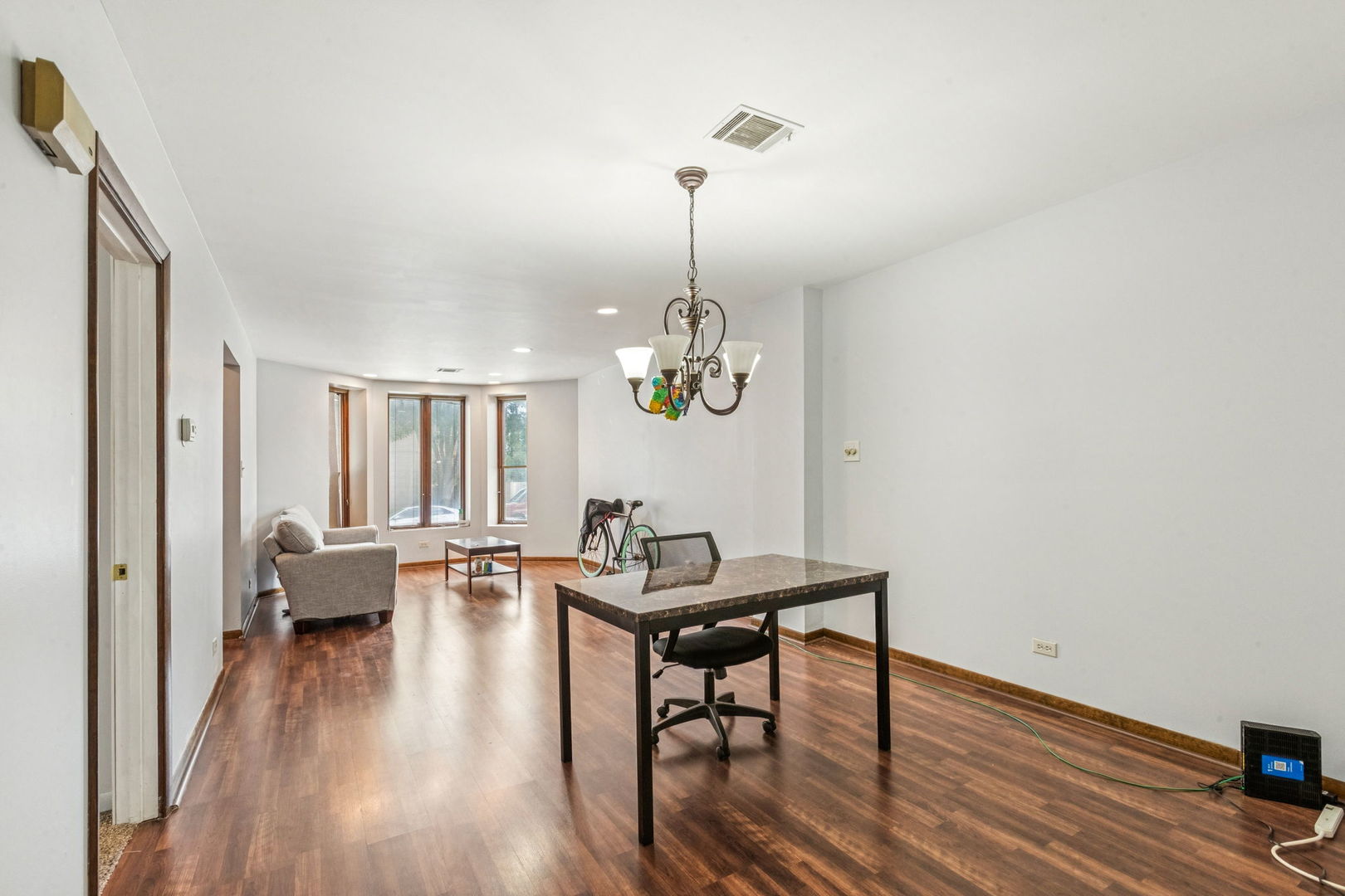 3234 South Princeton Avenue Chicago, IL 60616 - Photo 31 of 56 a living room with furniture and a chandelier